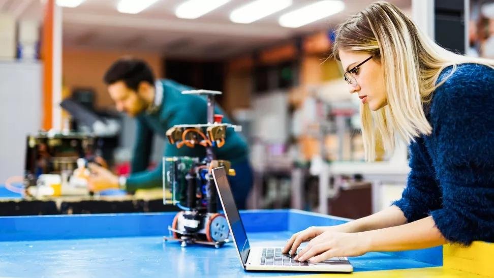 International students working in a high-tech engineering lab in Germany with advanced equipment