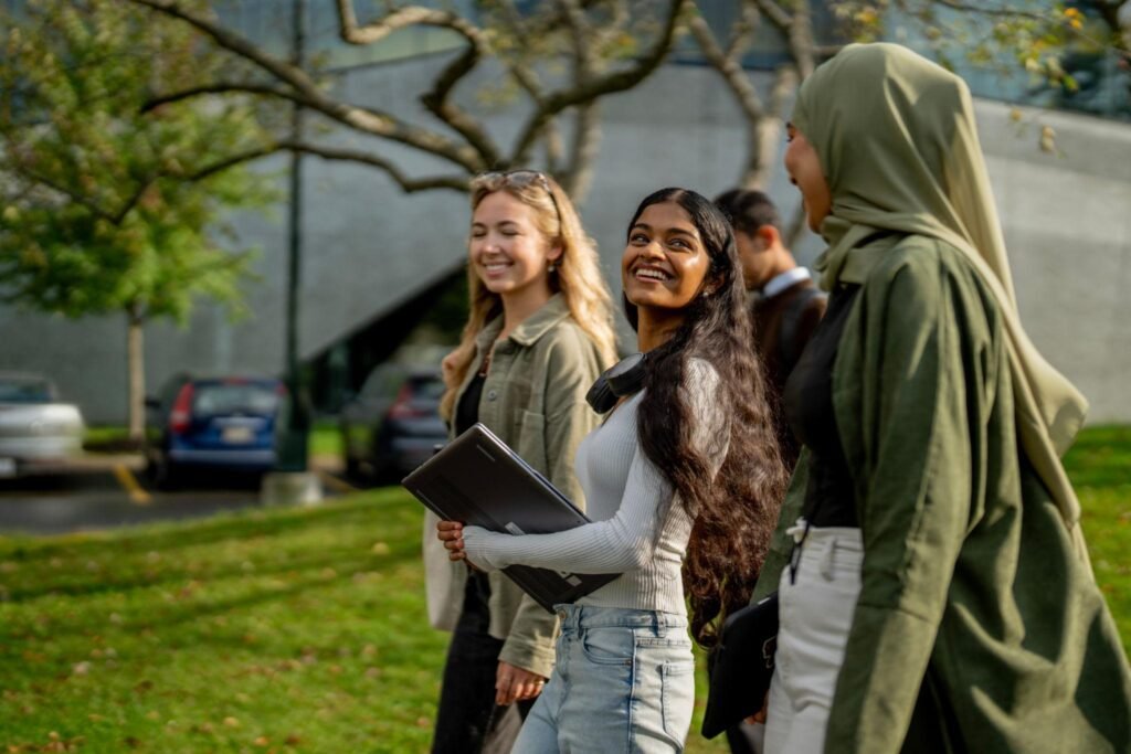 International students walking in a modern Canadian university campus with academic buildings