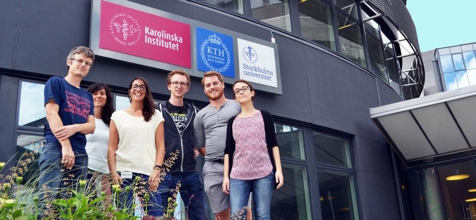 International students standing at a modern Swedish university campus with Nordic architecture